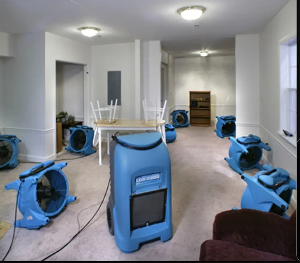 Air movers and dehumidifier setup for Water Damage Restoration in Ayden