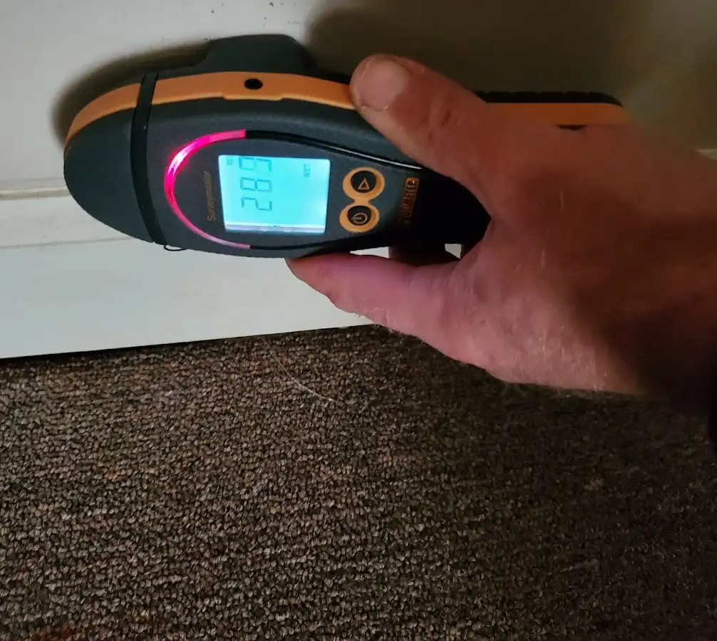 Moisture detection at baseboard during Storm Damage Restoration in Ayden